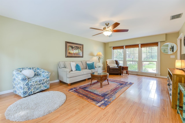 living room with ceiling fan and light hardwood / wood-style floors