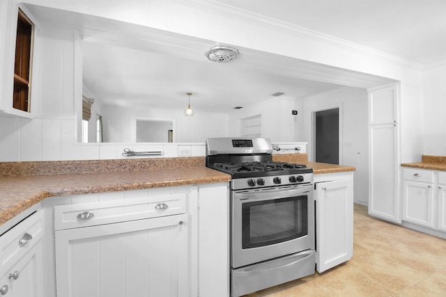 kitchen featuring stainless steel gas range, light tile patterned flooring, crown molding, and white cabinets