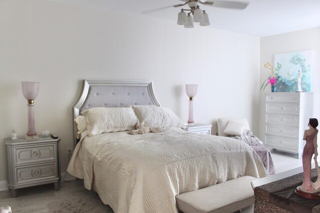 bedroom with ceiling fan and hardwood / wood-style floors