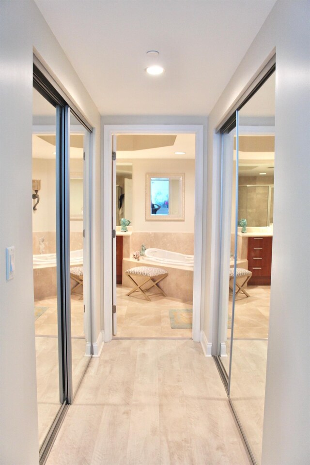 hallway with tile patterned floors