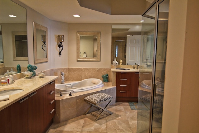 bathroom featuring vanity and separate shower and tub