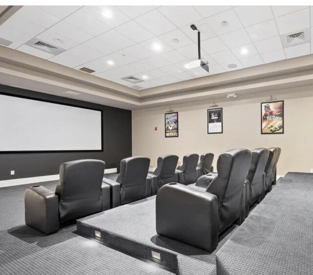 carpeted home theater with a drop ceiling and ceiling fan