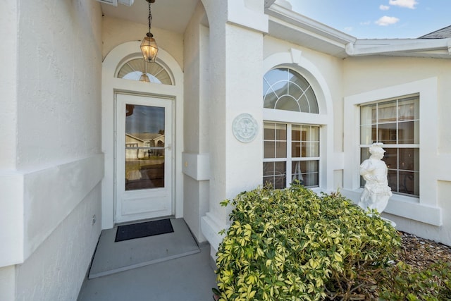entrance to property with stucco siding