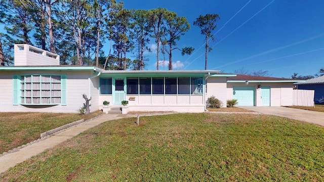 ranch-style house with a garage and a front yard