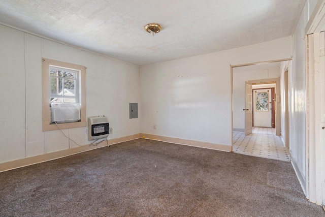 spare room with carpet flooring, a textured ceiling, heating unit, cooling unit, and electric panel