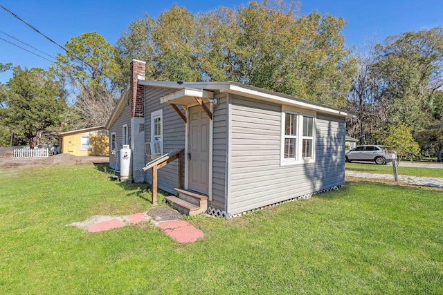 view of property exterior with a yard and cooling unit