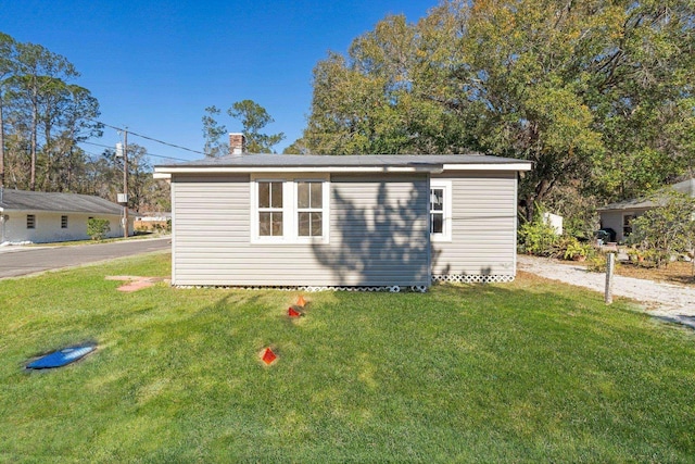 view of outbuilding with a yard