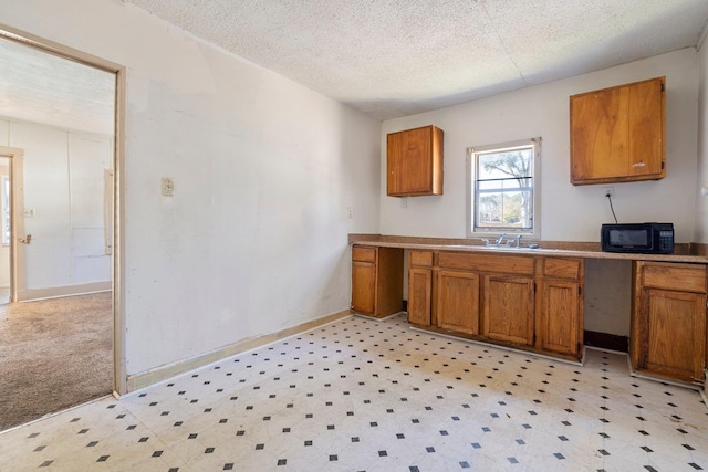 kitchen featuring sink and a textured ceiling