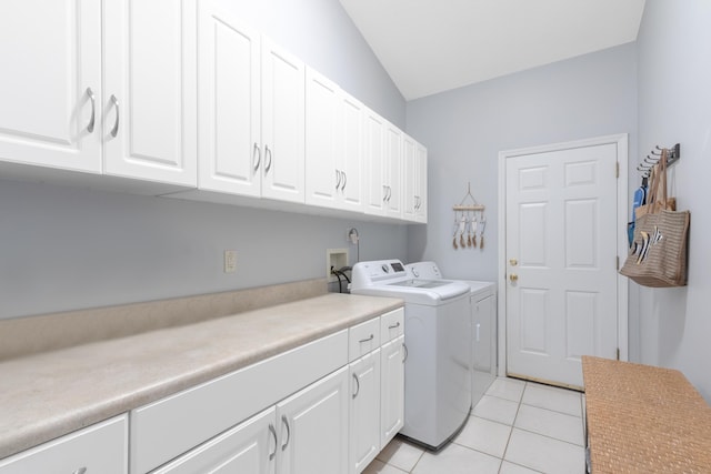 washroom with cabinets, washer and dryer, and light tile patterned floors