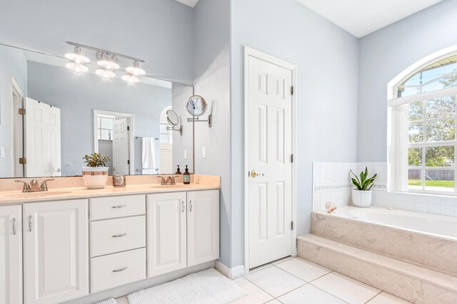 bathroom with vanity, a washtub, and tile patterned floors