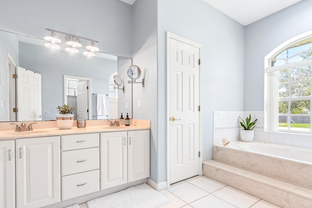 bathroom with vanity, a washtub, and tile patterned floors