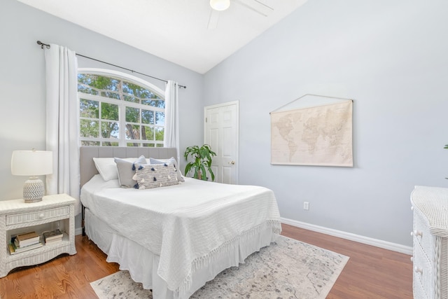 bedroom with lofted ceiling, hardwood / wood-style floors, and ceiling fan