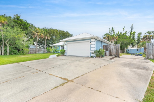 view of property exterior featuring a garage and a lawn