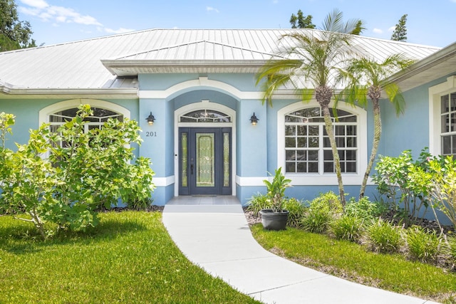 entrance to property with a yard