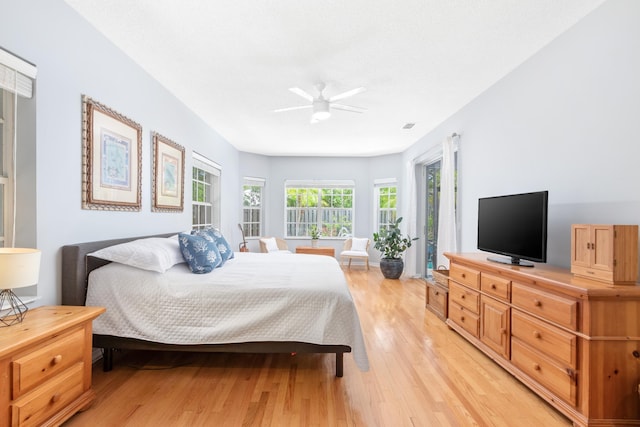 bedroom with ceiling fan, access to exterior, and light wood-type flooring