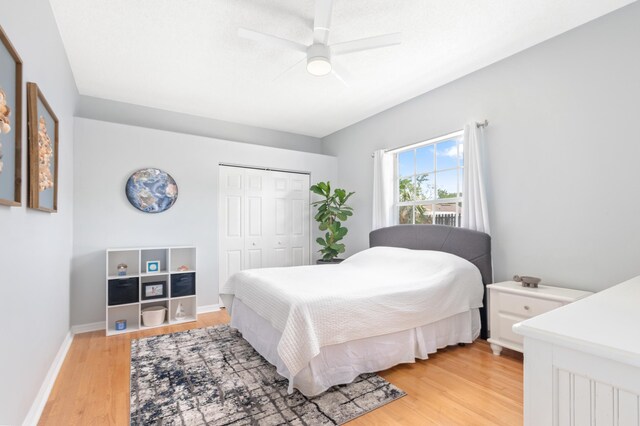 bedroom featuring light hardwood / wood-style flooring, a closet, and ceiling fan