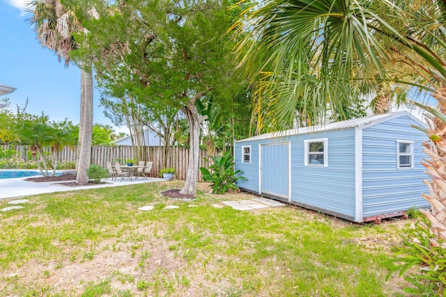 view of yard featuring a storage shed and a patio area