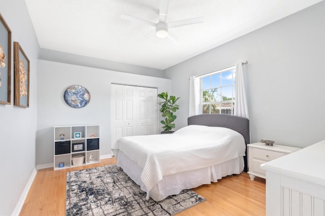 bedroom featuring ceiling fan, light hardwood / wood-style floors, and a closet