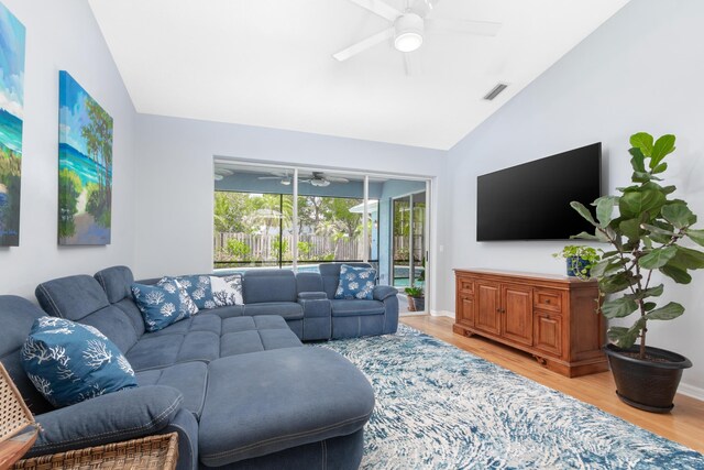 living room featuring wood-type flooring, lofted ceiling, and ceiling fan