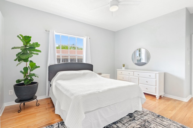 bedroom with ceiling fan and light wood-type flooring