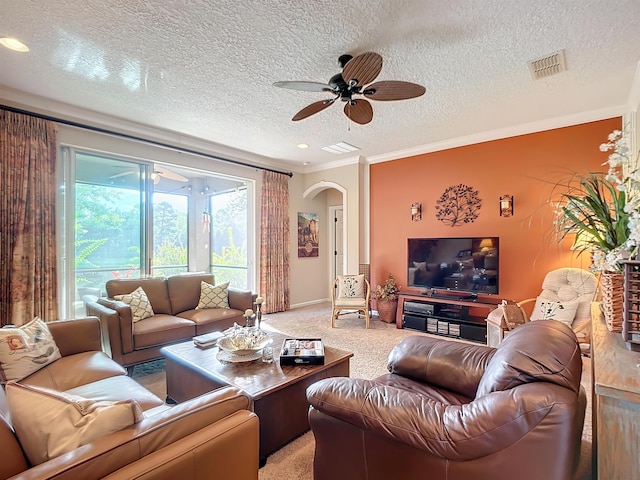 carpeted living room with ceiling fan, crown molding, and a textured ceiling