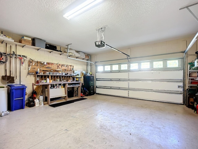 garage with a workshop area and a garage door opener