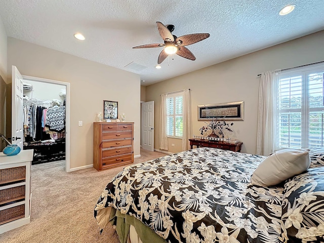 bedroom featuring multiple windows, a spacious closet, a closet, and ceiling fan