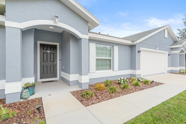 view of exterior entry featuring a garage