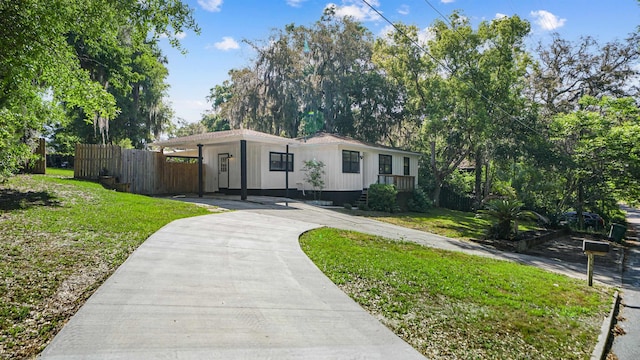 1403 S 15th St, Palatka, FL 32177 - view of front of home featuring concrete driveway, a front yard, and fence