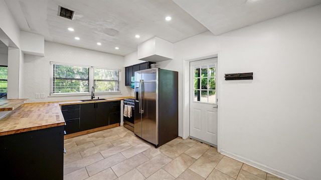 1403 S 15th St, Palatka, FL 32177 - kitchen featuring stainless steel fridge, a sink, dark cabinets, range with gas stovetop, and recessed lighting