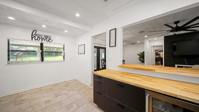1403 S 15th St, Palatka, FL 32177 - kitchen with light tile patterned floors, baseboards, ceiling fan, butcher block countertops, and beverage cooler