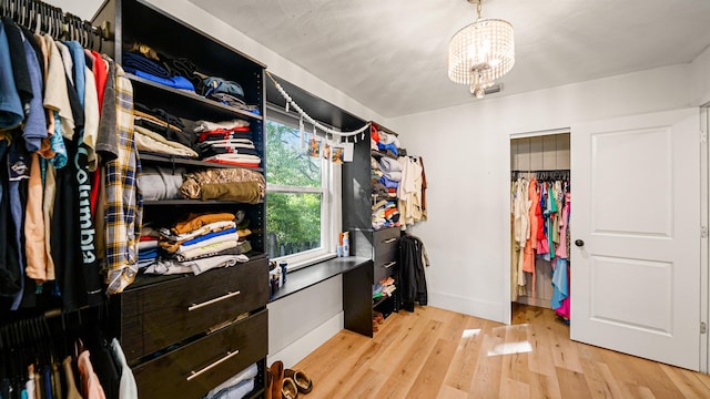1403 S 15th St, Palatka, FL 32177 - walk in closet with light wood finished floors and an inviting chandelier
