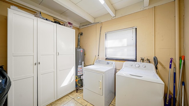 1403 S 15th St, Palatka, FL 32177 - laundry area featuring light tile patterned floors, gas water heater, concrete block wall, cabinet space, and washer and clothes dryer