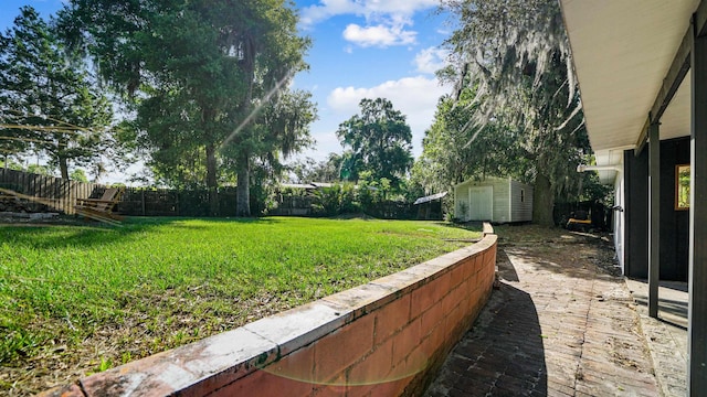 1403 S 15th St, Palatka, FL 32177 - view of yard with a fenced backyard, a storage unit, and an outdoor structure