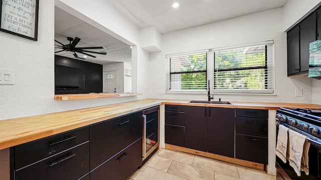 1403 S 15th St, Palatka, FL 32177 - kitchen featuring a sink, ceiling fan, wine cooler, wood counters, and stainless steel gas range oven