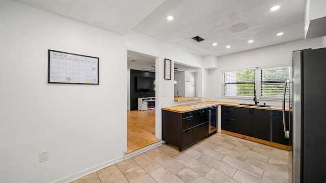 1403 S 15th St, Palatka, FL 32177 - kitchen with a sink, freestanding refrigerator, dark cabinetry, and recessed lighting