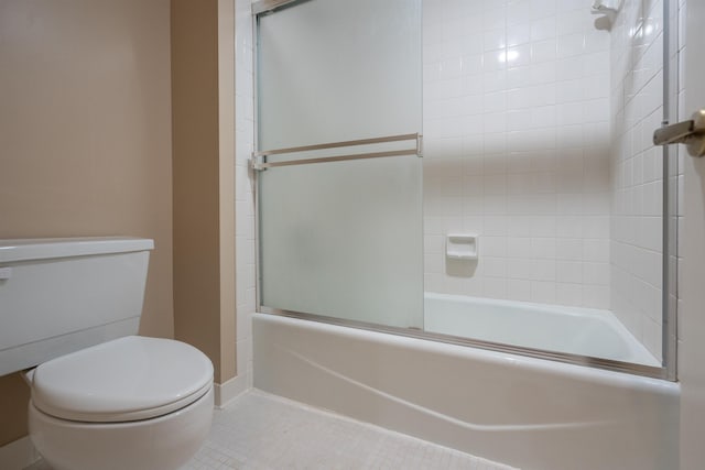 bathroom with shower / bath combination with glass door, tile patterned floors, and toilet