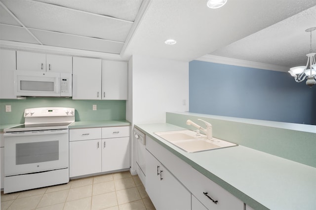 kitchen with pendant lighting, white appliances, crown molding, sink, and white cabinetry