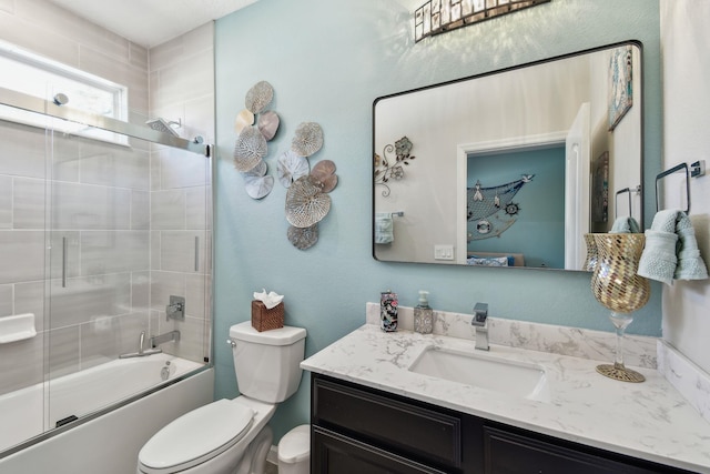 bathroom featuring bath / shower combo with glass door, vanity, and toilet