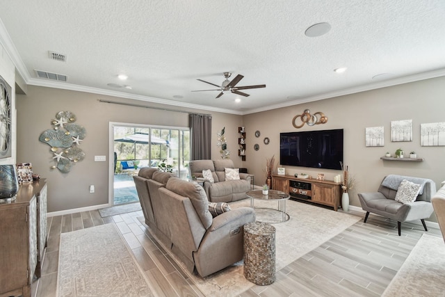 living room with a textured ceiling, wood finish floors, visible vents, and crown molding