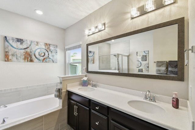 full bath with double vanity, a sink, a bath, and a shower stall