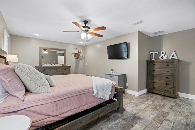 bedroom featuring light wood-type flooring, visible vents, and baseboards