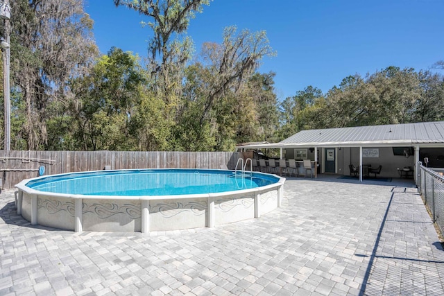 view of pool featuring a fenced in pool, a patio, and fence