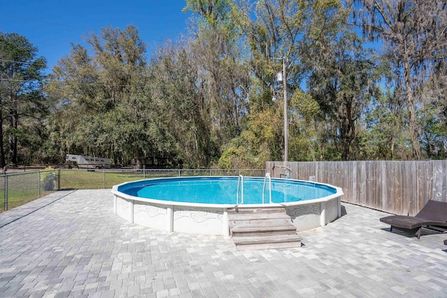 view of pool with fence, a fenced in pool, and a yard