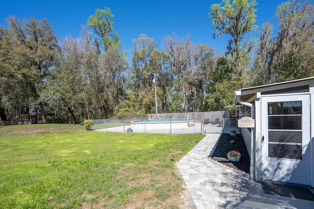 view of yard with fence and a fenced in pool