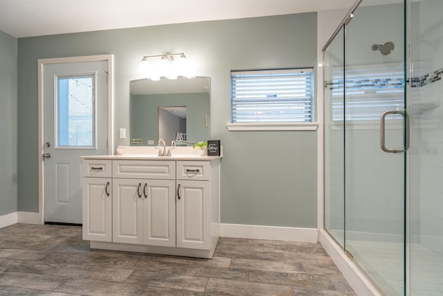 bathroom featuring a shower stall, a wealth of natural light, and baseboards