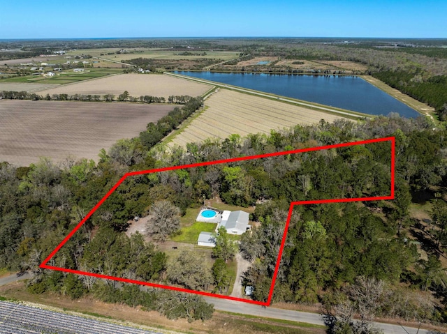 birds eye view of property featuring a water view and a rural view