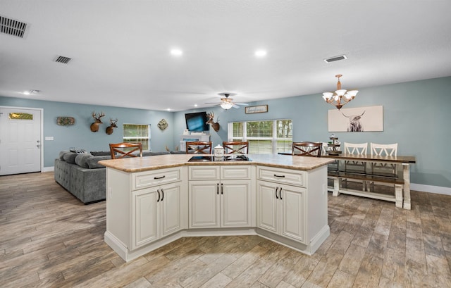 kitchen with light wood-type flooring and visible vents