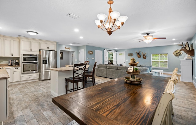 dining area with recessed lighting, ceiling fan with notable chandelier, visible vents, baseboards, and light wood-style floors