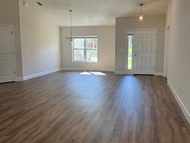 entrance foyer with a chandelier and dark hardwood / wood-style floors